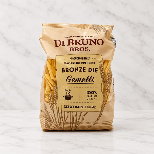 A 16 oz bag of Di Bruno Bros. Bronze Die Gemelli macaroni product, shown standing upright on a white studio background.