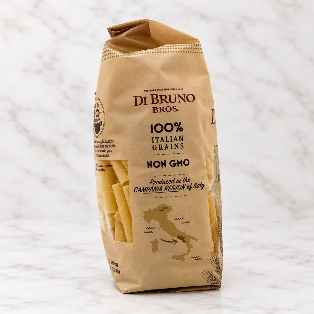 A bag of Di Bruno Bros. 100% Italian Grains Non GMO pasta, shown standing upright on a white studio background.