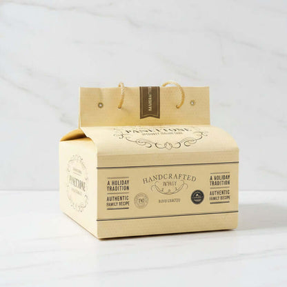 Panettone box with gold handle on a black surface
