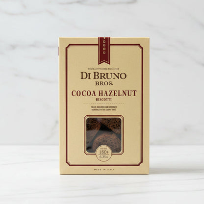 Box of Di Bruno Bros. Cocoa Hazelnut Biscotti on a black surface with a white background