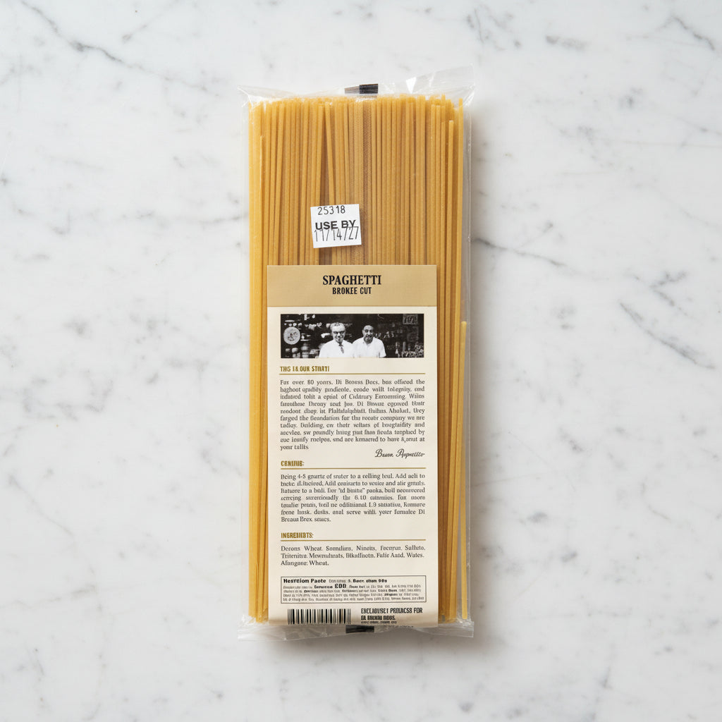 Spaghetti noodles in packaging with a label on a gray background