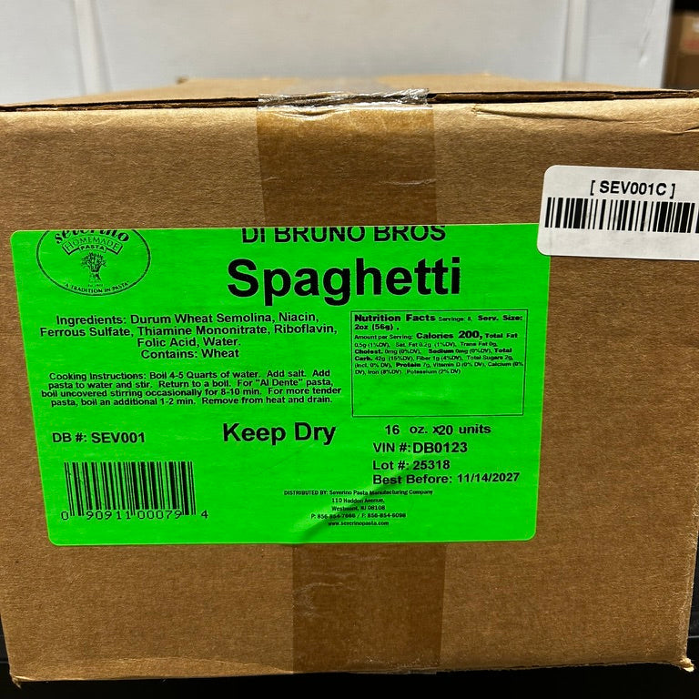 Box of Di Bruno Bros Spaghetti with a green label and barcode, in a warehouse setting.