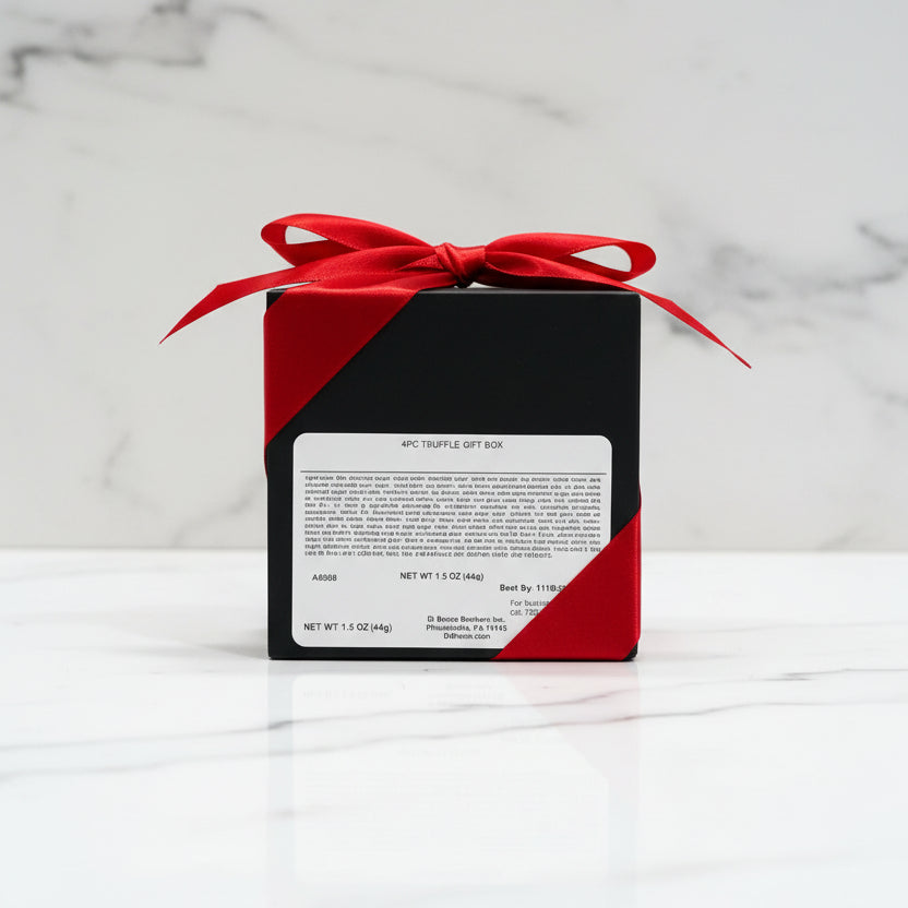 Black and red gift box with a red bow on a metallic surface