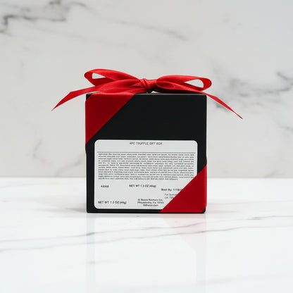 Black and red gift box with a red bow on a metallic surface