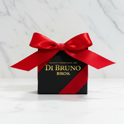 Small black box with a red ribbon featuring 'Di Bruno Bros.' on a gray surface.