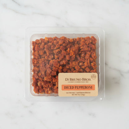 Packaged diced pepperoni from Di Bruno Bros on a dark surface