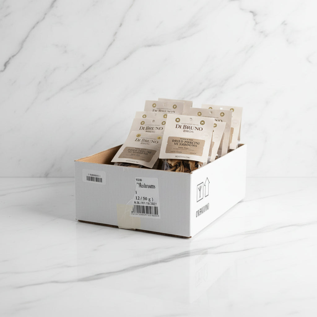 Box of DeBruno brand mushroom packages on a wooden pallet with 'Fragile' label.
