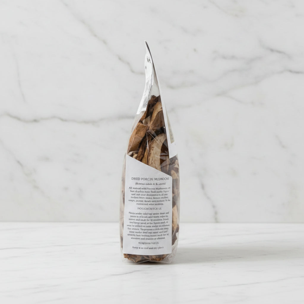 Packaged dried porcini mushrooms on a wooden surface with a blurred background