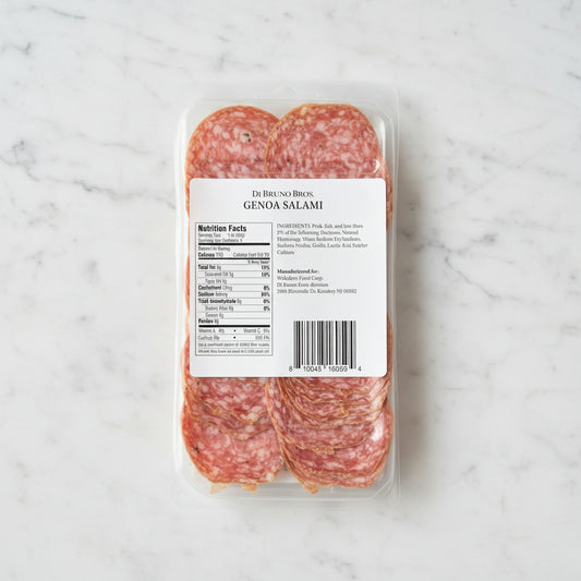 Packaged Genoa Salami with label on a dark background