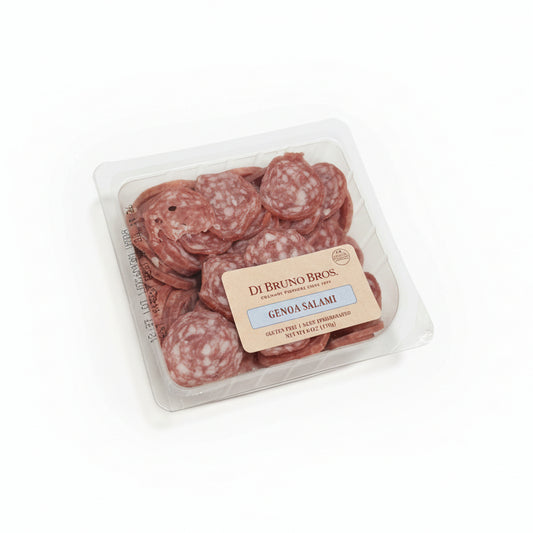 Packaged salami on a white surface with a brown background