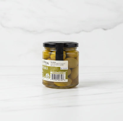 Jar of pickles on a white paper with a workshop background