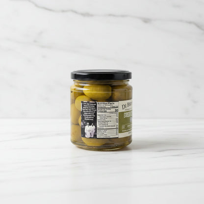 Jar of pickled green olives on a white background