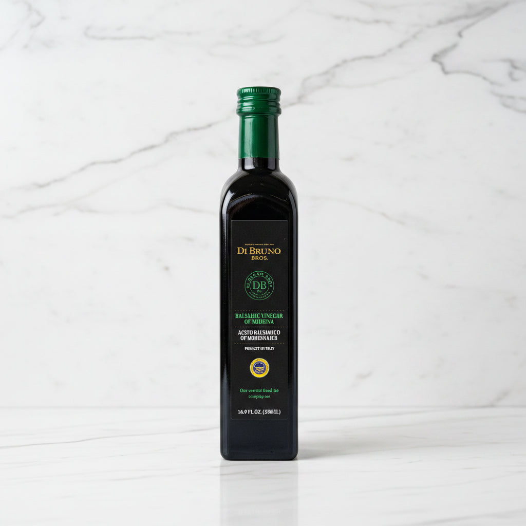Bottle of DeBruno olive oil on a reflective surface with a blurred background