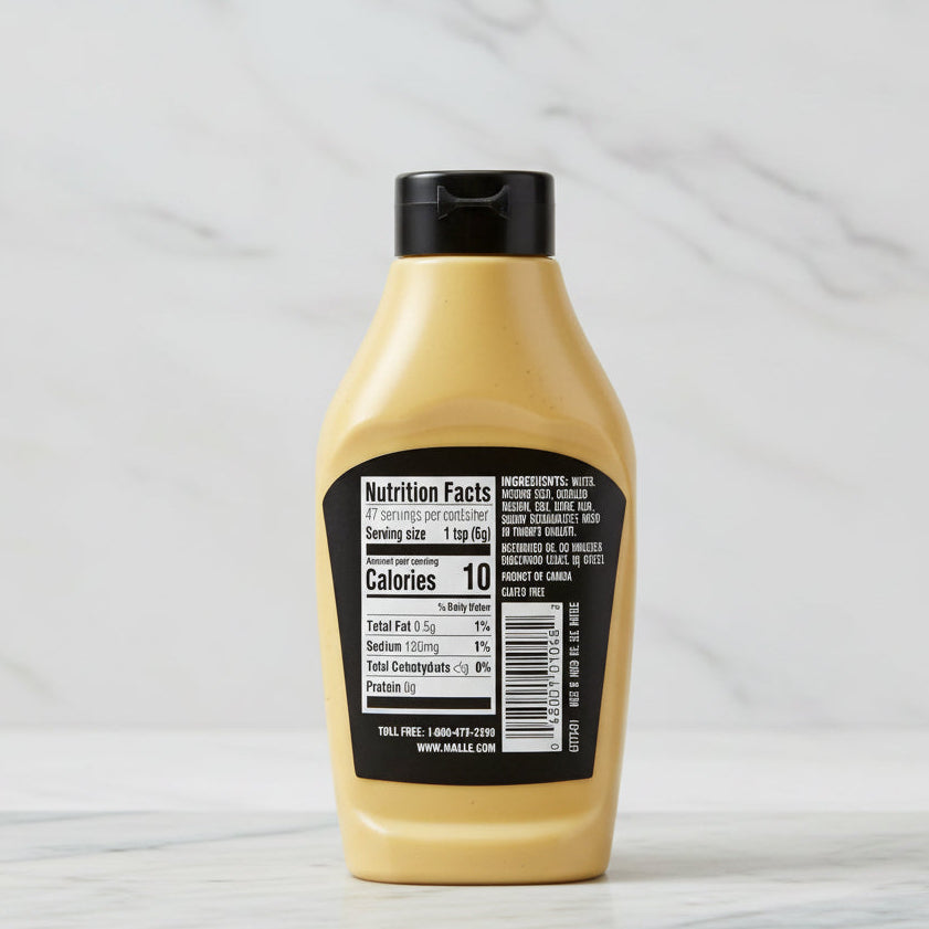 Mustard bottle with nutrition facts label on a white background