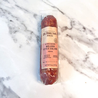 Packaged Milano Style Salami from Di Bruno Bros on a marble surface