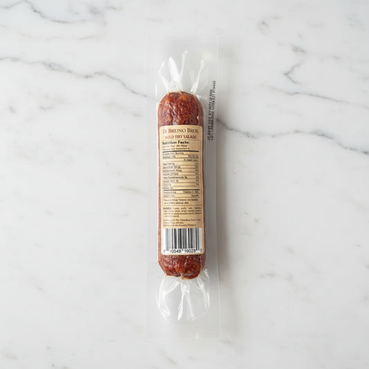 Packaged salami on a black surface