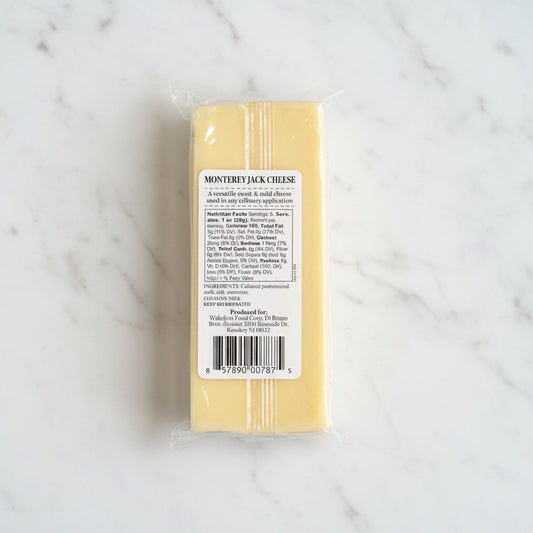 Block of Monterey Jack cheese with a label on a black background