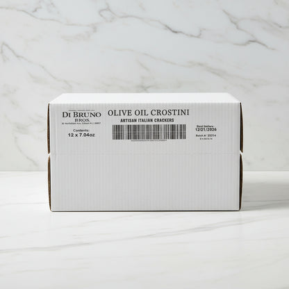 Stack of Di Bruno Bros. olive oil crostini boxes in a warehouse setting