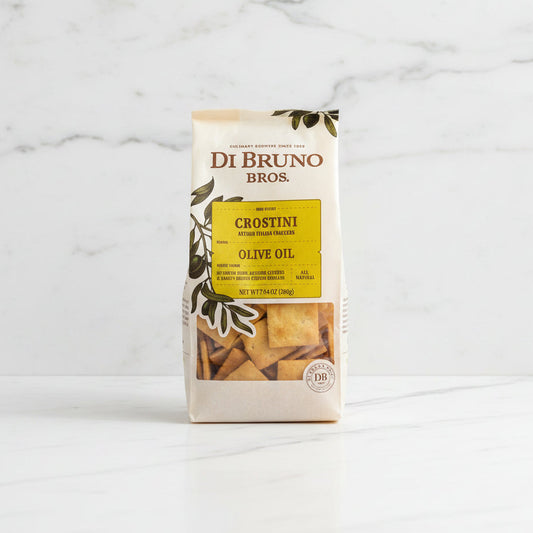 Bag of Di Bruno Bros Crostini Olive Oil on a dark surface with a light gray background