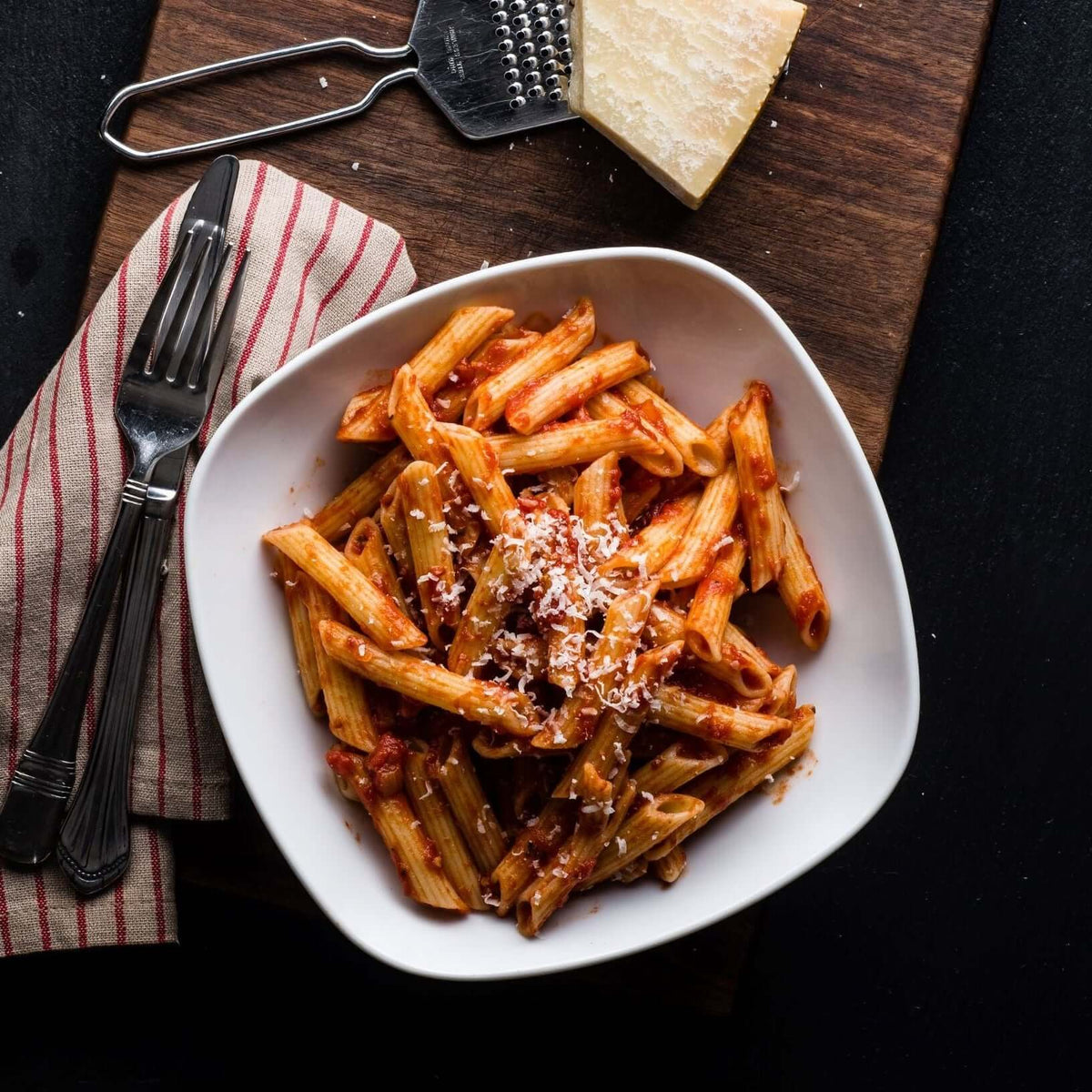 Penne pasta with premium tomato basil pasta sauce and grated cheese.