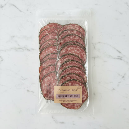 Packaged peppered salami with a visible brand label on a dark surface