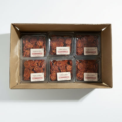 Box of packaged dried fruits with visible labels on a cardboard box.