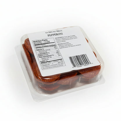 Packaged pepperoni with a label on a white surface
