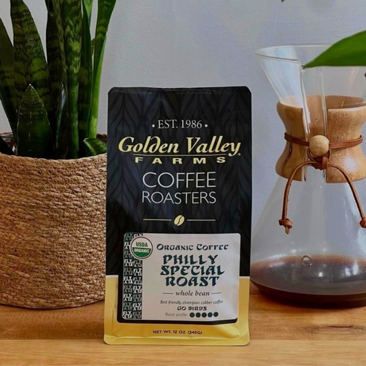 Fightin' Fanatic Roast Organic Coffee, 12-Ounce Bag with black packaging, displayed on a marble surface.