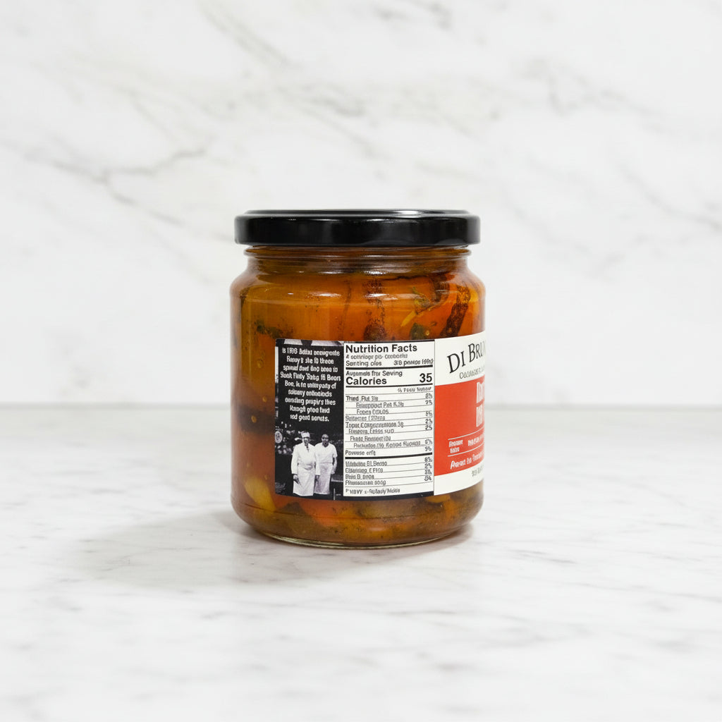 Jar of pickled vegetables on a dark surface with a white tiled wall in the background