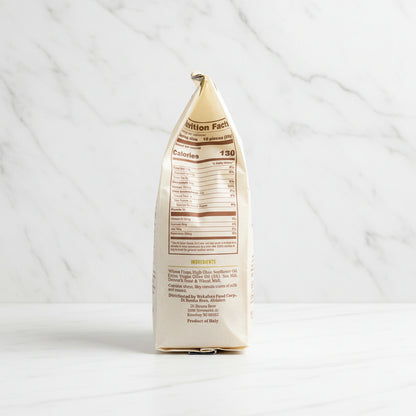 Back view of a coffee package with nutrition facts label on a dark surface