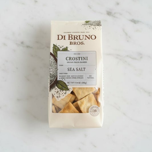 Di Bruno Bros Crostini Sea Salt packaging on a black surface with a white background