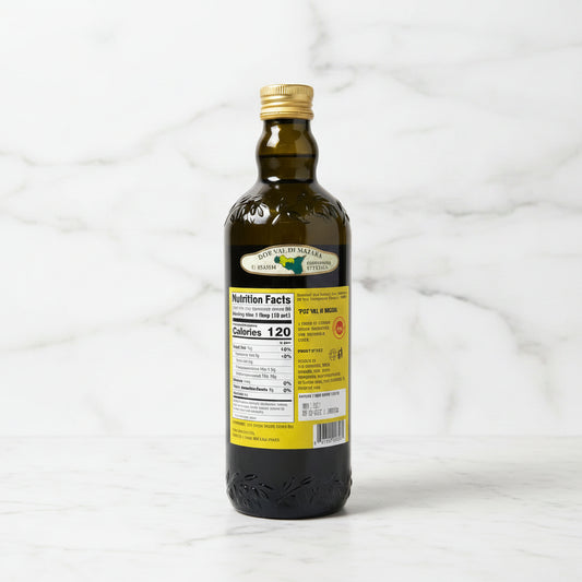Bottle of olive oil with a label on a dark surface