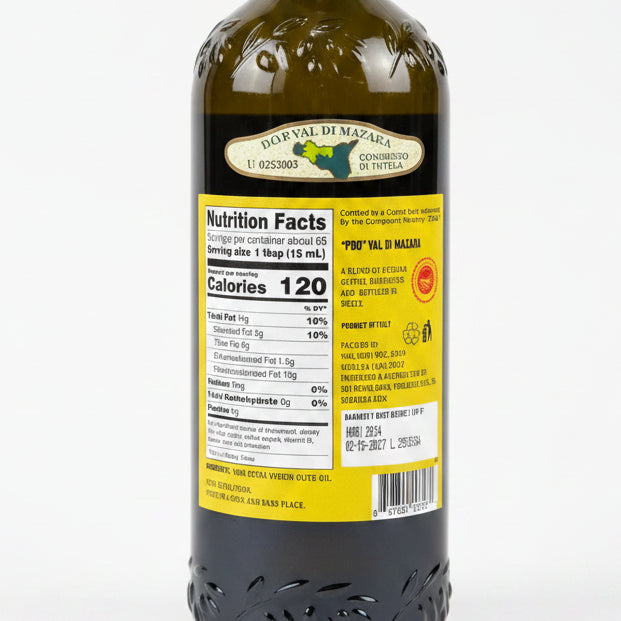 Bottle of olive oil with a label on a black surface