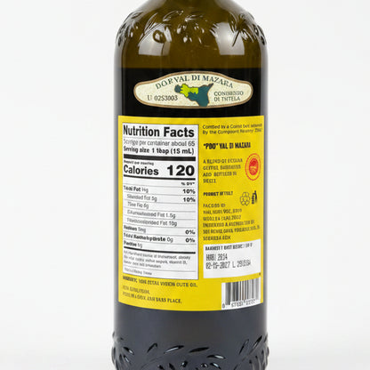Bottle of olive oil with a label on a black surface
