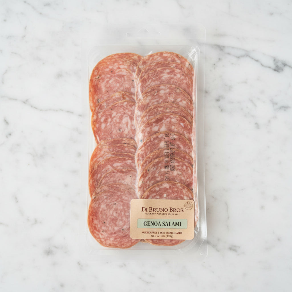 Packaged Genoa Salami from Di Bruno Bros on a dark background
