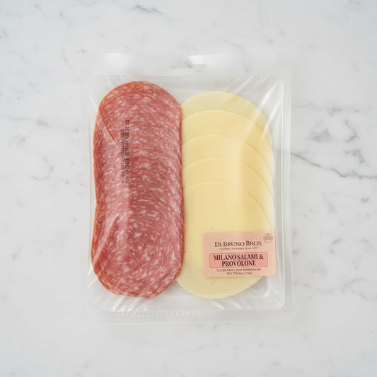 Packaged deli meat with salami and provolone cheese on a black surface