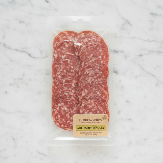 Packaged salami with a label on a dark background