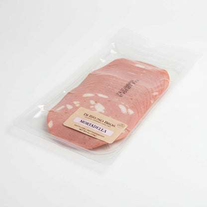 Packaged mortadella slices with a label on a white surface