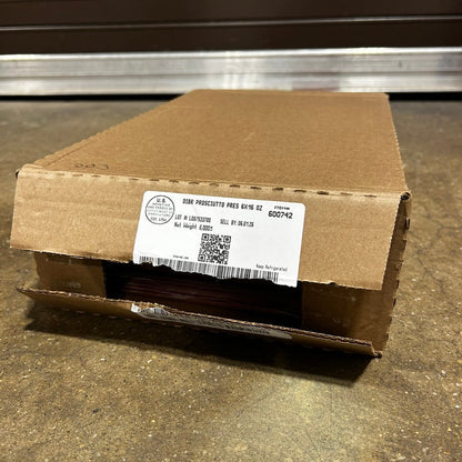 Cardboard box with a label on a concrete floor