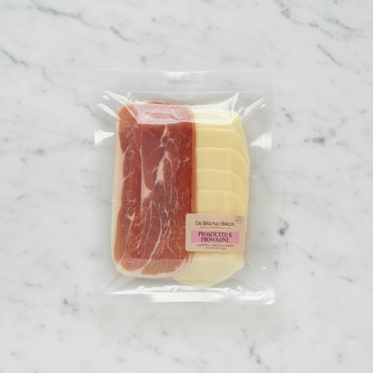 Packaged prosciutto and provolone cheese with Di Bruno Bros label on a black background
