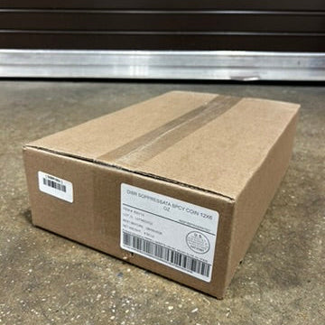 Cardboard box with labels on a concrete floor