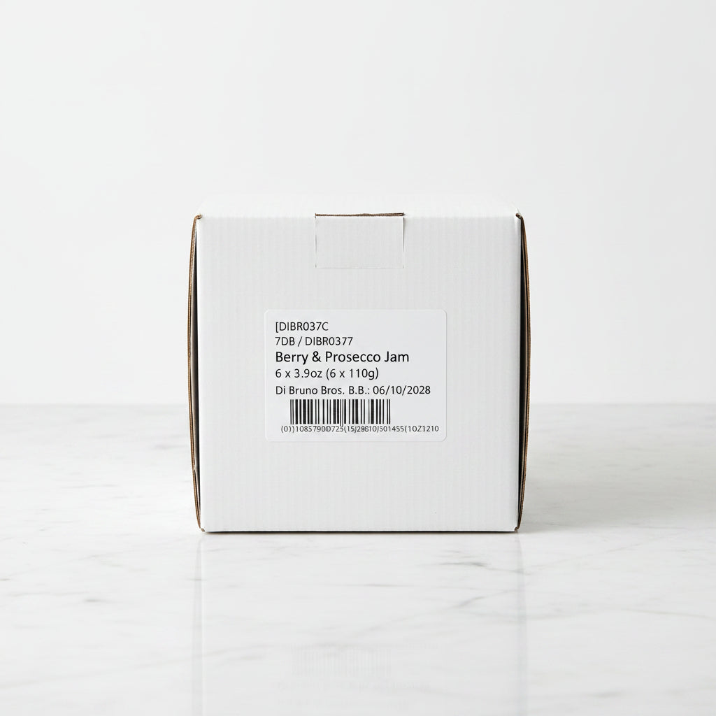 Box of Di Bruno Bros. Y & Prosecco Jam on a black surface with a warehouse background