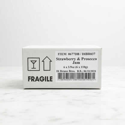 Box of Strawberry & Prosecco Jam with fragile label on a black surface
