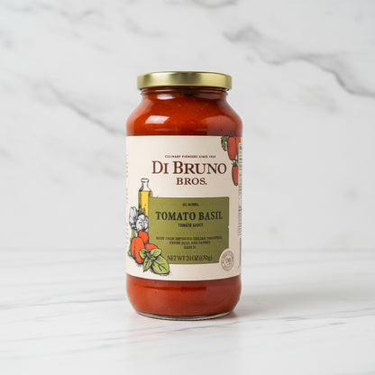 Jar of Di Bruno Bros Tomato Basil sauce on a black surface with a white background