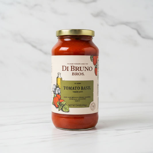 Jar of Di Bruno Bros Tomato Basil sauce on a black surface with a white background