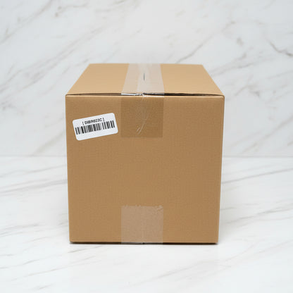 Cardboard box with a barcode label on a black surface