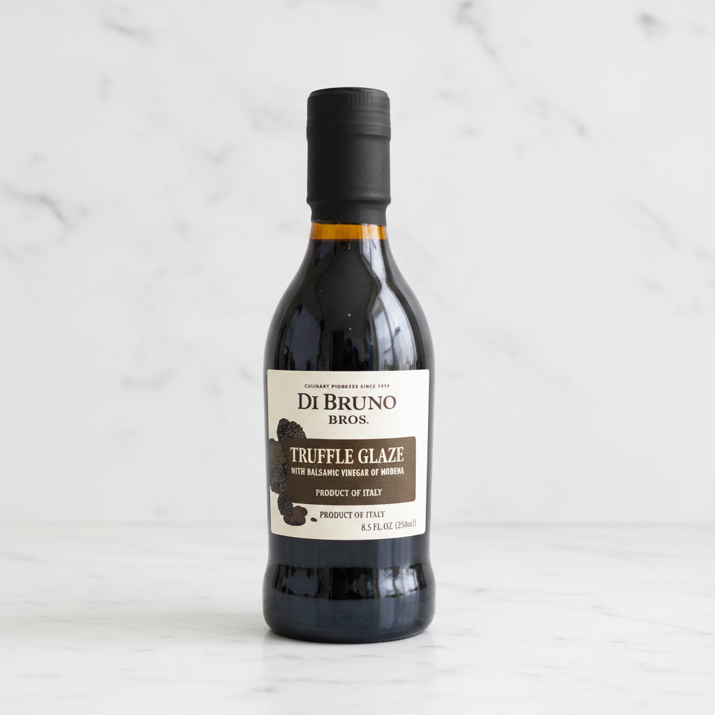 Bottle of Di Bruno Bros. Truffle Glaze on a gray surface with a white background