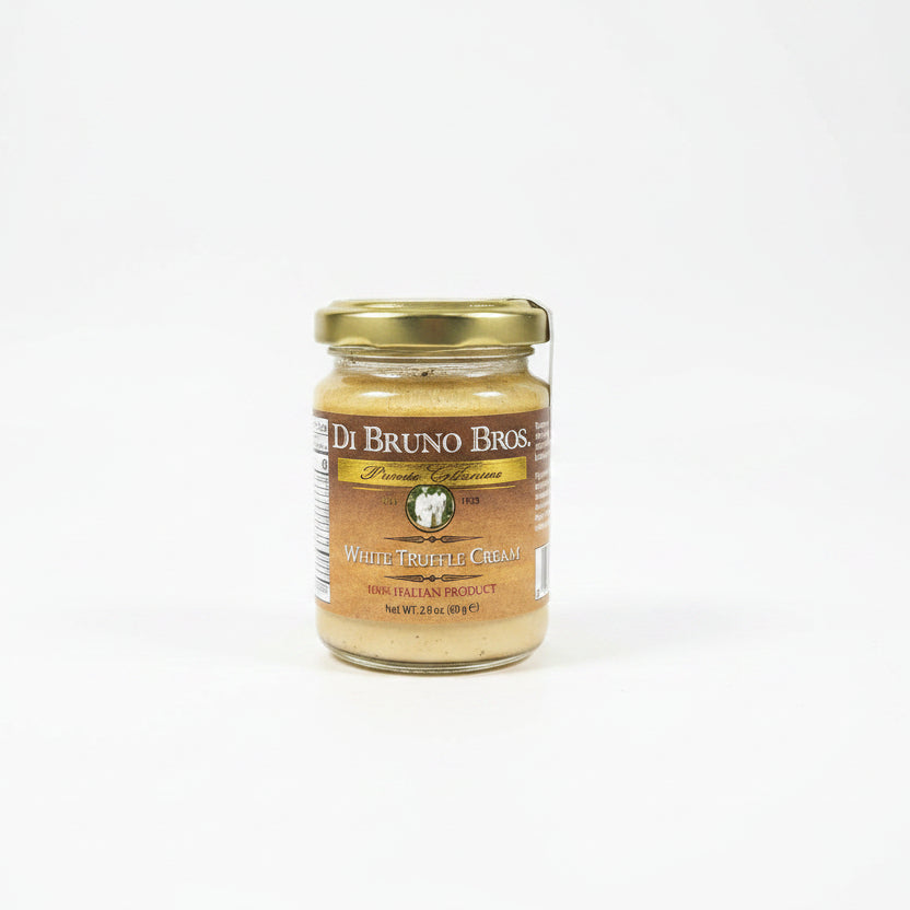 Jar of Di Bruno Bros. truffle cream on a dark surface with a white background