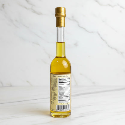 Small bottle with a gold cap and label on a black surface.