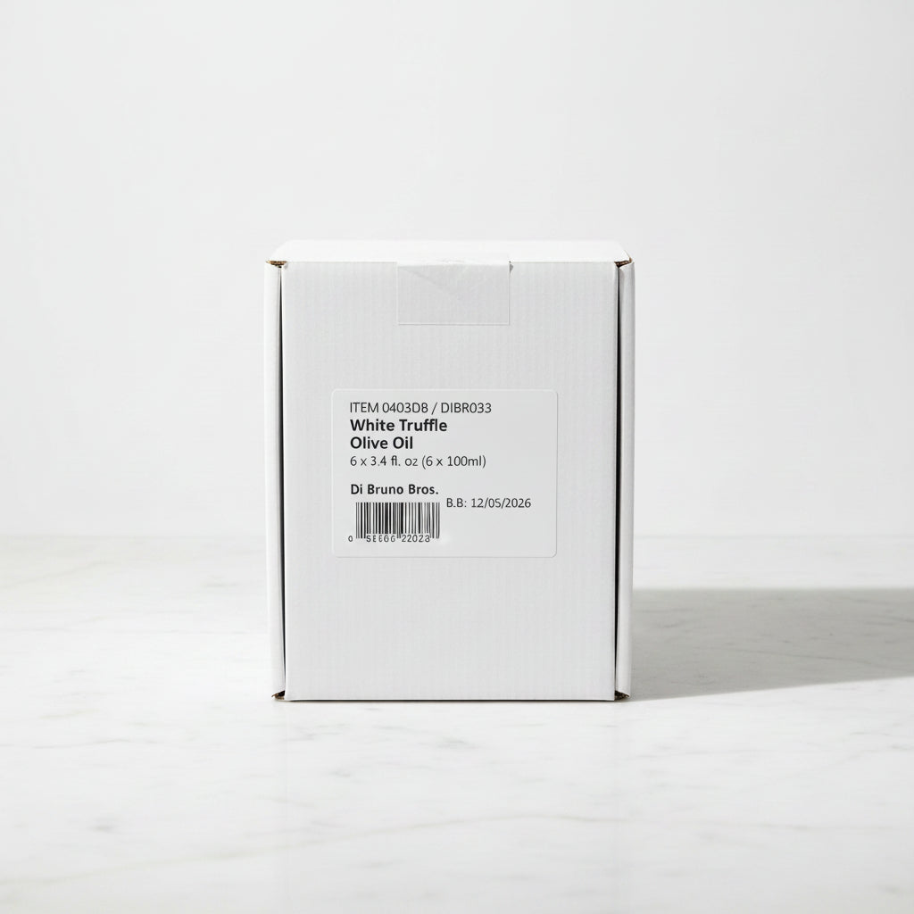 Box of White Truffle Olive Oil on a dark surface with a light gray background